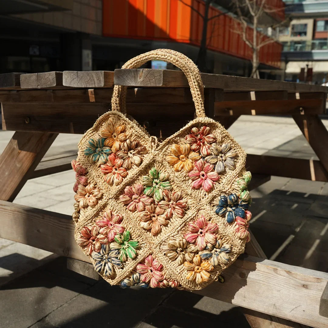 New French Handmade Lafite Grass Hollowed Out Woven Flower Petal Pattern Portable Women's Bag Seaside Vacation Fashion Bag Trend