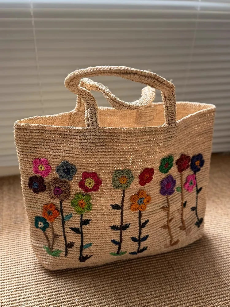 New French Handmade Lafite Grass Hollowed Out Woven Flower Petal Pattern Portable Women's Bag Seaside Vacation Fashion Bag Trend